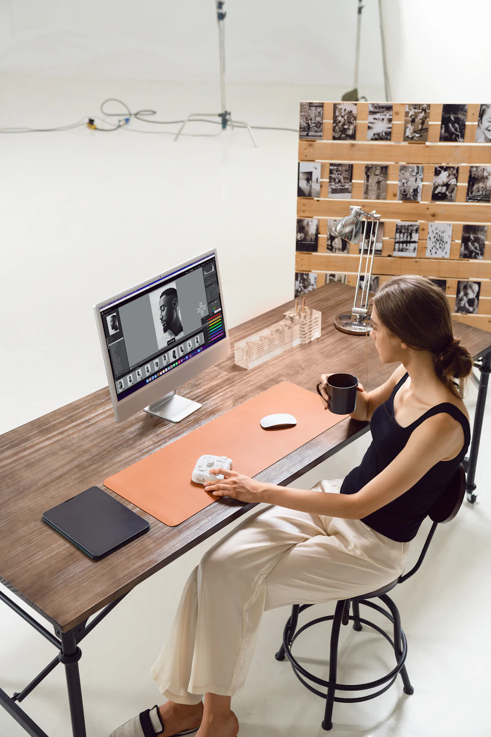 Photo editor reviewing a polished client gallery on a studio desktop