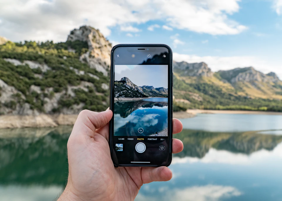 Hand holding a smartphone previewing a photo before sharing