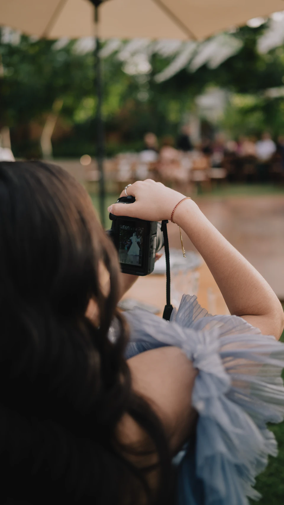 Photographer capturing a live outdoor event with a professional camera